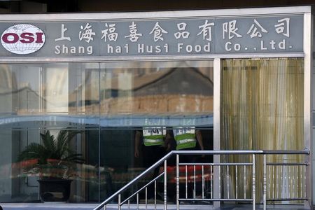 © Reuters. Security guards stand inside the Husi Food factory in Shanghai