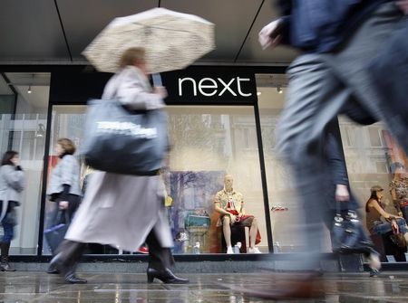 © Reuters. Pedestrians walk past a Next shop in Oxford Street in London