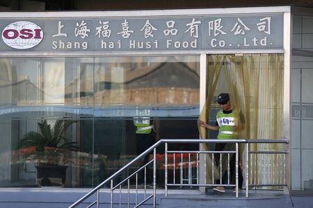 © Reuters. A man walks out of the entrance of Husi Food factory in Shanghai