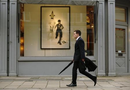 © Reuters. A man passes a gallery in London