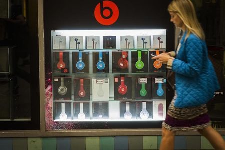 © Reuters. A pedestrian walks past a Beats brand display in the subway system of New York