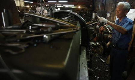 © Reuters. A man works inside a factory in Tokyo