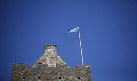 © Reuters. Scotland's flag, the Saltire, flies on top of Dean Castle in Kilmarnock