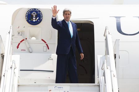 © Reuters. Secretário de Estado norte-americano, John Kerry, acena ao embarcar em avião após visita à Índia