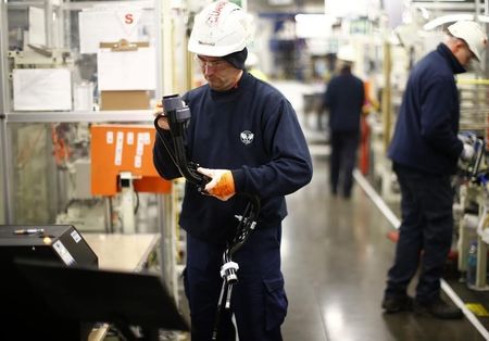 © Reuters. A worker inspects a component on the fuel inlet production facility in Foston