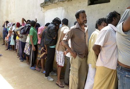 © Reuters. Sri Lankan asylum seekers who were sent back by Australia wait to enter a magistrate's court in Galle