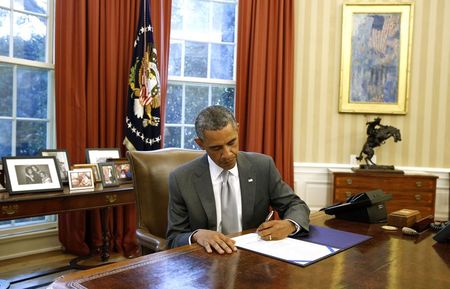 © Reuters. U.S. President Barack Obama signs H.J. Res. 76, Emergency Supplemental Appropriations Resolution, 2014, while in the Oval Office in the White House in Washington