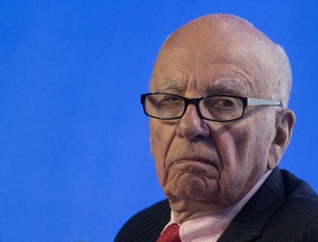 © Reuters. File of Murdoch, executive chairman of News Corporation, reacts during a panel discussion at the B20 meeting of company CEOs in Sydney