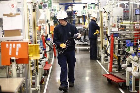 © Reuters. A worker inspects a component on the fuel inlet production facility in Foston