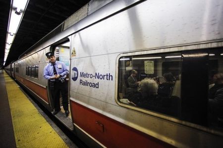 © Reuters. An MTA worker looks out for commuters before the train's departure at Grand Central Station in New York