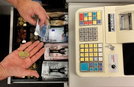 © Reuters. Euro banknotes and small coins are pictured in open cash register in Olching