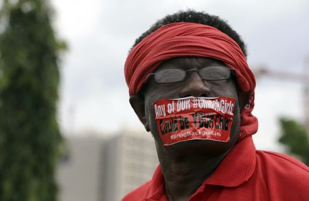 © Reuters. A demonstrator looks on during a rally that was held to mark the 120th day since the abduction of two hundred school girls by the Boko Haram, in Abuja