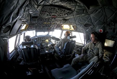 © Reuters. The crew of a German Bundeswehr Transall C-160 plane carrying humanitarian aid is pictured in the cockpit as the plane flies over Turkey