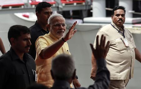 © Reuters. Indian Prime Minister Narendra Modi walks down the gangplank of the newly commissioned warship, INS Kolkata, after its commissioning ceremony at a naval base in Mumbai