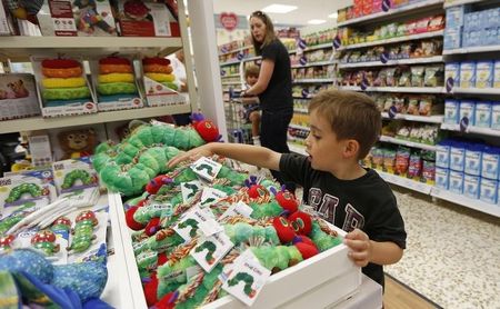 © Reuters. Davter, 5, of Bushey looks at a toy display as he shops with his mother and sister at a Tesco Extra supermarket in Watford, north of London