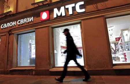 © Reuters. A man walks past a MTS shop in St.Petersburg