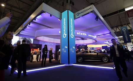 © Reuters. File photo of visitors walking past the Qualcomm stand at the Mobile World Congress in Barcelona