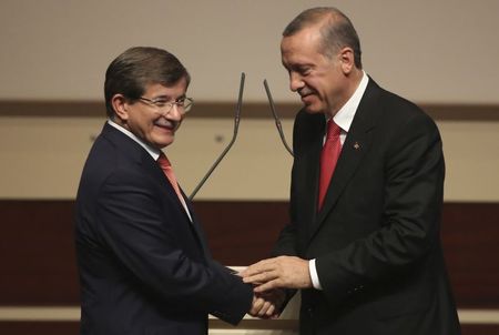 © Reuters. Turkey's PM Erdogan shakes hands with Foreign Minister Davutoglu during a meeting at the AK Party headquarters in Ankara