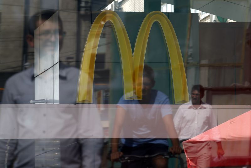 &copy; Reuters People are reflected in a window of a closed McDonald's restaurant, one of four temporarily closed by the state food safety watchdog, in Moscow