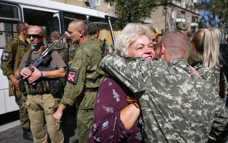 © Reuters. A woman pro-Russian supporter greets one of the rebels after a rally in Donetsk