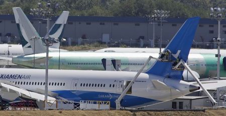 © Reuters. Workers on lifts are pictured near the tail of a Boeing 787-8 Dreamliner being built for for Xiamen Airlines in Everett, Washington