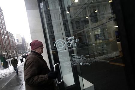 © Reuters. A man enters the Time Warner Cable headquarters in New York