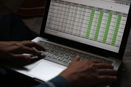 © Reuters. IT consultant Ainun shows a table of voting results that was used in his work on the Indonesian elections in Singapore