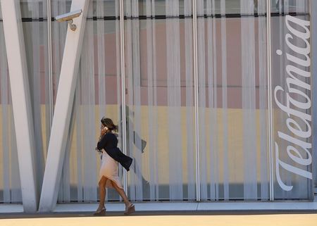 © Reuters. A woman walks past a Telefonica building in Barcelona