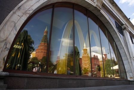 © Reuters. The walls and towers of the Kremlin are reflected in a window of a closed McDonald's restaurant, one of four temporarily closed by the state food safety watchdog, in Moscow