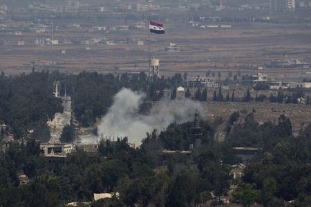 © Reuters. Smoke rises following an explosion on the Syrian side near the Quneitra border crossing