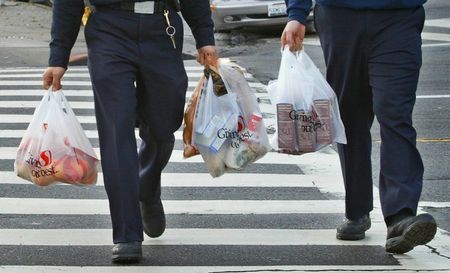 © Reuters. Firemen walk with plastic grocery bags in San Francisco