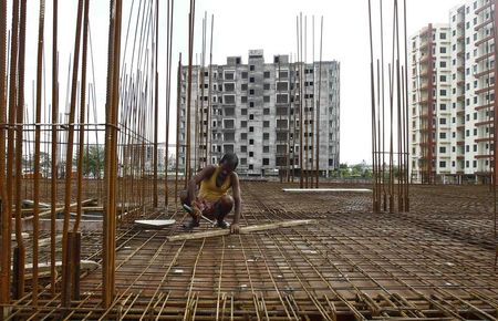 © Reuters. A labourer works at the construction site of a residential complex in Kolkata