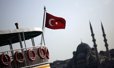 © Reuters. A Turkish flag, with the Ottoman-era New mosque in the background, flies over a passenger ferry in Istanbul