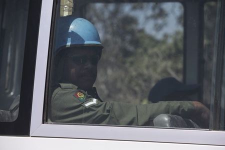 © Reuters. A U.N. peacekeeper from Fiji is seen through a bus window in the Israeli-occupied Golan Heights