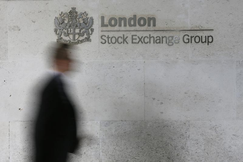 &copy; Reuters A man walks past the London Stock Exchange in the City of London