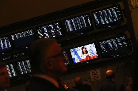 © Reuters. Attendants of a ceremony at Buenos Aires' Stock Exchange watch as Argentina's President Cristina Fernandez de Kirchner speaks, in Buenos Aires