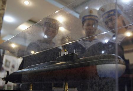 © Reuters. usnFile picture of sailors looking at a model of a submarine scheduled for delivery to Vietnam in 2013, in Hai Phong