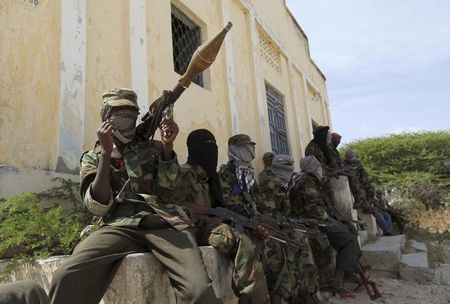 © Reuters. Al Shabaab soldiers sit outside a building during patrol along the streets of Dayniile district in Southern Mogadishu