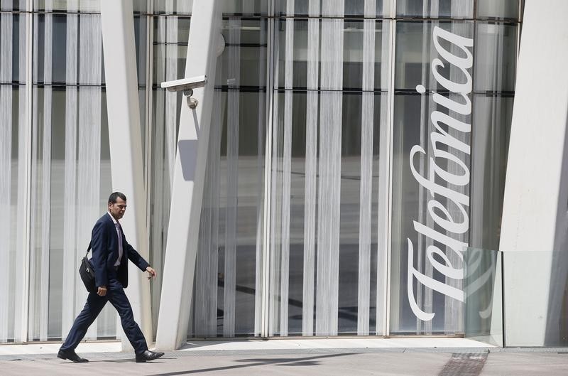 &copy; Reuters A man walks past a Telefonica building in Barcelona