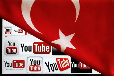 © Reuters. YouTube logos displayed on a laptop screen partially covered with Turkey's national flag in this photo illustration taken in Ankara