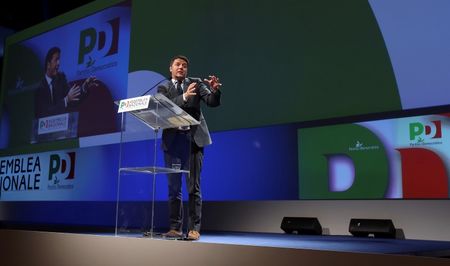 © Reuters. New elected centre-left Democratic Party (PD) leader Renzi gestures during his first national meeting in Milan