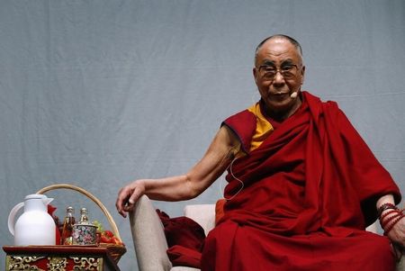 © Reuters. Tibetan spiritual leader the Dalai Lama looks on during a public talk at the Fraport Arena in Frankfurt