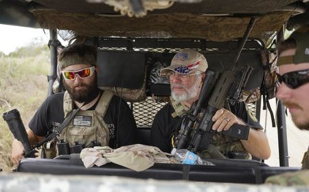 © Reuters. Members of the "Patriots" patrol in their UTV near a camp of patriots near the U.S.-Mexico border outside Brownsville, Texas