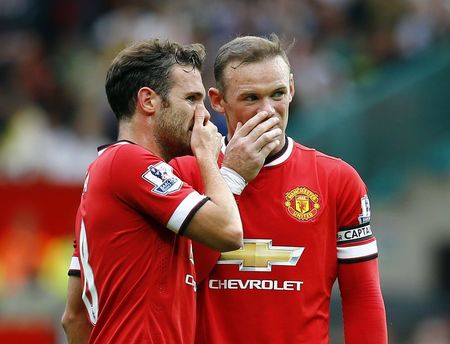 © Reuters. Manchester United's Rooney and Mata discuss before taking a freekick during their English Premier League soccer match against Swansea City at Old Trafford in Manchester