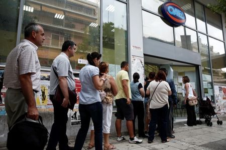 © Reuters. People wait outside a Greek Manpower Employment Organisation (OAED) office in a suburb of Athens