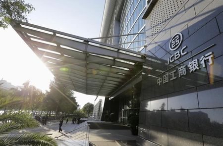 © Reuters. People stand in front of ICBC headquarters building in Beijing