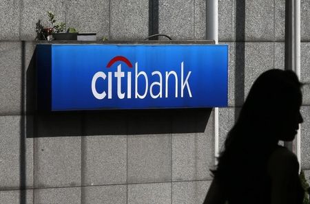 © Reuters. A woman walks past a Citibank logo displayed outside the Citibank Plaza in Hong Kong