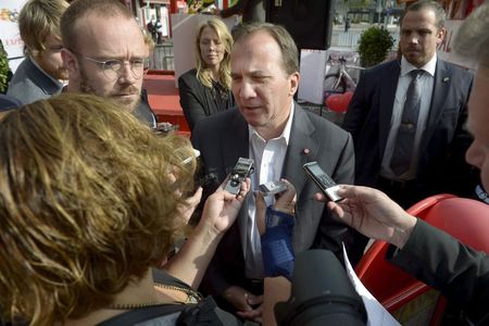 © Reuters. Lofven answers questions after a hearing made by the newspaper Expressen in Sergels Torg in central Stockholm