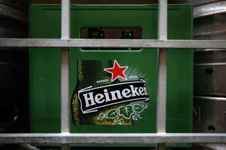 © Reuters. A plastic container with empty bottles of Heineken beers are pictured among beer kegs outside a restaurant in Singapore