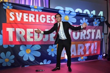 © Reuters. Party leader Jimmie Akesson gestures in front of a poster at the election night party of the Sweden Democrats in Stockholm